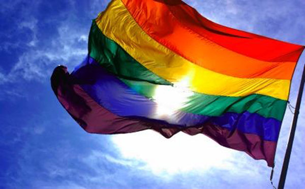 An LGBTQ pride flag blows in the wind