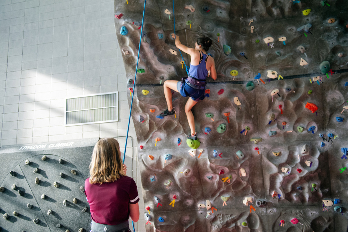 Student rock climbing at university recreation