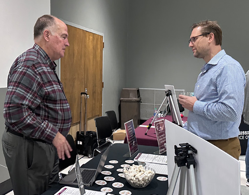 Disability Resource Center Director Chris Dallager speaks with a faculty member at the Student Experience Expo.